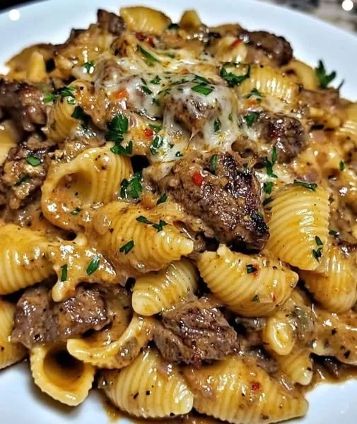 Creamy paprika steak shells served in a bowl with fresh herbs