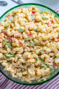 A colorful bowl of honey mustard pasta salad with fresh vegetables