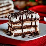 Delicious slice of Oreo Fudge Ice Cream Cake topped with whipped cream and Oreos